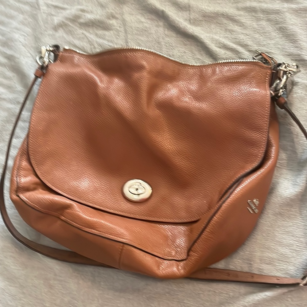 Tan Coach bag with crossbody option. Used and probably around 5 years old.